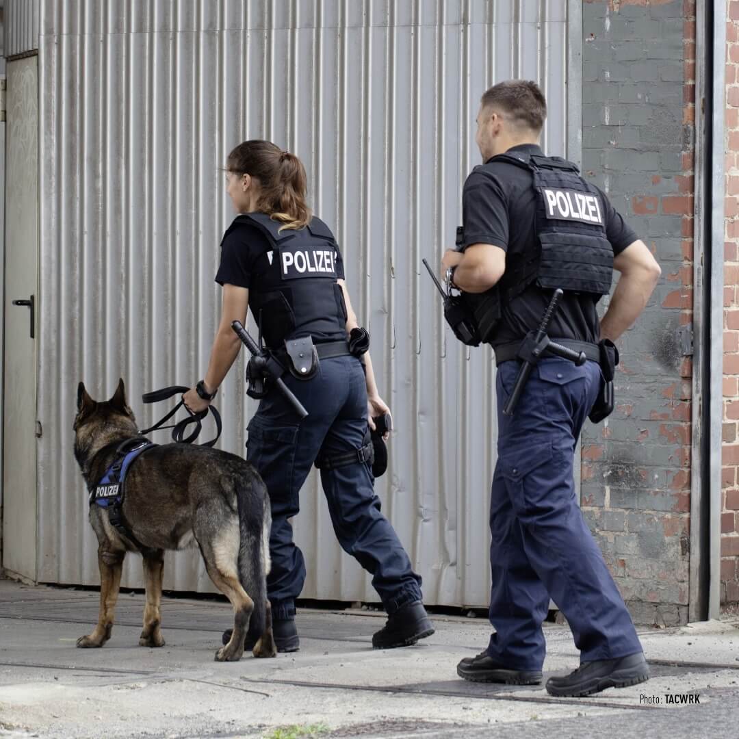 Two police officers with a police dog